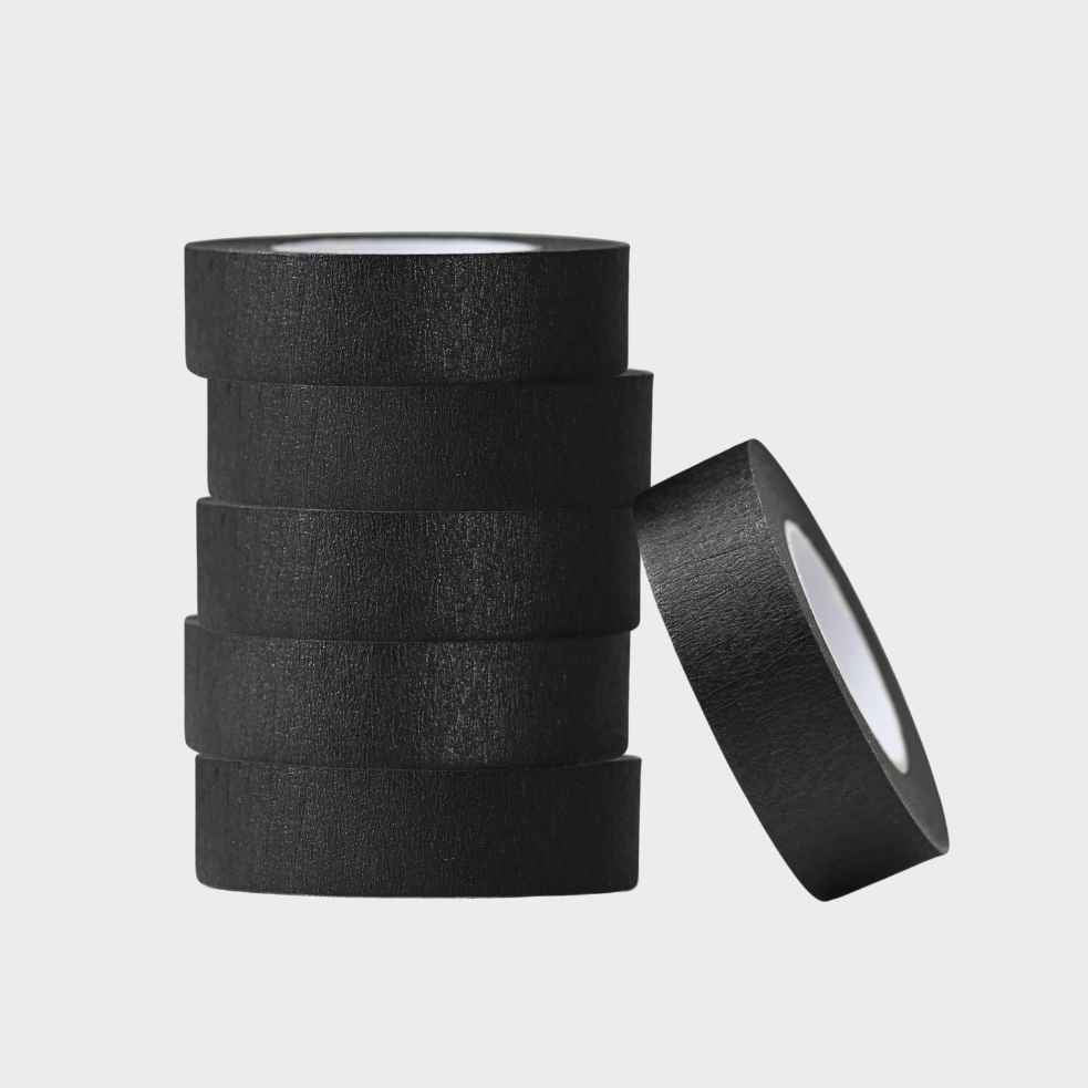 Stack of black tape with one roll lying on a light gray background
