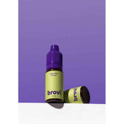 Two Brovi One e-liquid bottles in 'deep dark brown' flavor, one standing upright and the other lying on its side, set against a solid purple background with a white surface below.