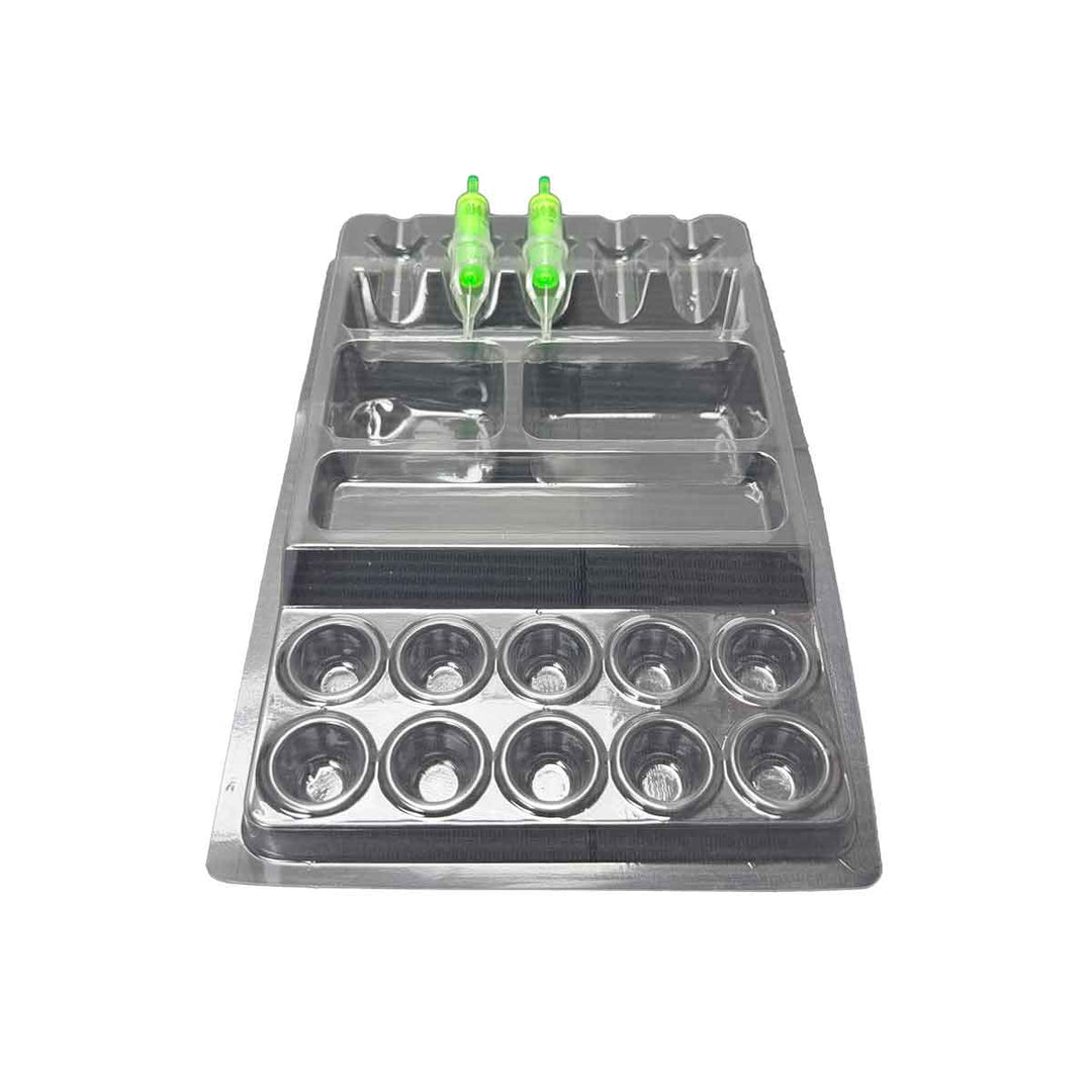 Tattoo work tray with multiple compartments and green bottles on a white background